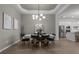 Cozy dining room features modern lighting, decor, seating for six, with easy access to kitchen at 17632 Santorini Ct, Venice, FL 34293