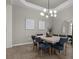 Elegant dining room features modern lighting, decor, seating for eight, and ample space for gatherings at 17632 Santorini Ct, Venice, FL 34293
