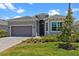 Beautiful single-story home featuring manicured lawn and a neutral gray color palette at 17632 Santorini Ct, Venice, FL 34293