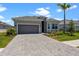 Charming single-Gathering home with a well-manicured lawn, paved driveway, and two-car garage at 17632 Santorini Ct, Venice, FL 34293