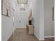 Open foyer boasting wood-look flooring, light walls, and an elegant light fixture at 17632 Santorini Ct, Venice, FL 34293