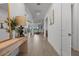Bright and airy foyer with wood-look tile flooring, leading into the home's open layout at 17632 Santorini Ct, Venice, FL 34293