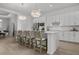 Open kitchen with a large island perfect for entertaining or casual dining with pendant lights and stainless appliances at 17632 Santorini Ct, Venice, FL 34293