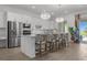 Bright kitchen features stainless steel appliances, an island with barstool seating, and stylish pendant lighting at 17632 Santorini Ct, Venice, FL 34293