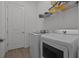 This laundry room has modern washer and dryer units at 17632 Santorini Ct, Venice, FL 34293