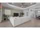 Spacious living room with a contemporary fan, recessed lighting, neutral colors, and a comfortable sectional sofa at 17632 Santorini Ct, Venice, FL 34293