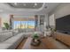 Comfortable living room with a sectional sofa and view of the lanai at 17632 Santorini Ct, Venice, FL 34293
