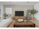 Stylish living room showcasing modern decor, a large TV, and lots of natural light at 17632 Santorini Ct, Venice, FL 34293