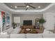 Inviting living room featuring a large TV, comfortable seating, and stylish décor, perfect for relaxation at 17632 Santorini Ct, Venice, FL 34293