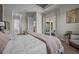 A spacious primary bedroom with a king bed, a large window, and easy access to the bathroom at 17632 Santorini Ct, Venice, FL 34293