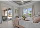 Primary bedroom suite featuring a king bed, a large window, and access to an outdoor living area at 17632 Santorini Ct, Venice, FL 34293