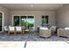 Inviting covered patio space with dining and lounge areas with modern tiled flooring at 17632 Santorini Ct, Venice, FL 34293