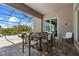 Covered patio with lounge chairs and dining area overlooking pool at 17632 Santorini Ct, Venice, FL 34293