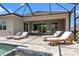 Screened-in pool and patio area with dining, lounge seating and sun loungers at 17632 Santorini Ct, Venice, FL 34293