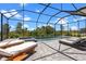 Screened-in pool with sun loungers offering a serene and private outdoor retreat at 17632 Santorini Ct, Venice, FL 34293