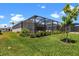 Enjoy outdoor living with a screened lanai overlooking a beautifully landscaped yard at 17632 Santorini Ct, Venice, FL 34293