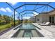 Backyard features a screened-in pool and patio offering relaxation and privacy at 17632 Santorini Ct, Venice, FL 34293
