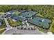 Aerial view of the community tennis courts featuring multiple courts with shade covers at 17632 Santorini Ct, Venice, FL 34293