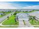 Beautiful aerial view of a single-Gathering home, lush lawn, lake view, and paver driveway with 3-car garage at 17898 Cherished Loop, Bradenton, FL 34211