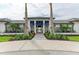 Elegant clubhouse entrance with manicured landscaping, stone accents, and bright blue shutters at 17898 Cherished Loop, Bradenton, FL 34211
