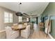 Well-lit dining room features an elegant light fixture and transitions into a comfortable living space at 17898 Cherished Loop, Bradenton, FL 34211