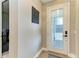 Elegant foyer featuring a decorative accent wall, a stylish front door, and sleek flooring at 17898 Cherished Loop, Bradenton, FL 34211