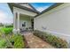 Inviting front porch with cozy seating area and beautifully landscaped entryway at 17898 Cherished Loop, Bradenton, FL 34211
