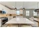 Stylish kitchen with stainless appliances, quartz countertops and a large center island at 17898 Cherished Loop, Bradenton, FL 34211