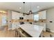 Bright and airy kitchen featuring white cabinetry, quartz countertops, and modern fixtures at 17898 Cherished Loop, Bradenton, FL 34211