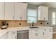Well-equipped kitchen with white cabinets, quartz countertops, and stainless steel appliances at 17898 Cherished Loop, Bradenton, FL 34211