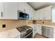 Close-up of a modern kitchen with stainless steel appliances and quartz countertops at 17898 Cherished Loop, Bradenton, FL 34211