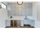 Stylish kitchenette featuring sleek cabinetry, wine fridge, ample storage and modern sink at 17898 Cherished Loop, Bradenton, FL 34211