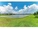 Picturesque view of the lake and well-manicured lawn at 17898 Cherished Loop, Bradenton, FL 34211