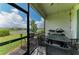 Screened-in lanai with dining set and grill overlooking the beautiful lake at 17898 Cherished Loop, Bradenton, FL 34211