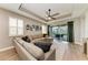 Spacious living room with sliding doors and decorative light fixtures, perfect for relaxation and entertaining at 17898 Cherished Loop, Bradenton, FL 34211