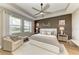 Serene main bedroom boasts tray ceilings, ample natural light, and calming decor for a restful retreat at 17898 Cherished Loop, Bradenton, FL 34211