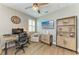 Bright office featuring wood floors, computer, built-in shelving, and natural lighting at 17898 Cherished Loop, Bradenton, FL 34211