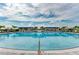 Large community pool with lounge chairs, shaded areas, and well-manicured landscaping for relaxation at 17898 Cherished Loop, Bradenton, FL 34211