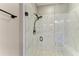 Walk-in shower features glass door and marble tile at 17898 Cherished Loop, Bradenton, FL 34211