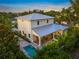 Aerial view of the meticulously landscaped backyard with pool, covered patio, and the home's elegant exterior at 1954 Goldenrod St, Sarasota, FL 34239