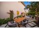 Inviting backyard patio area with an outdoor table, chairs, and lush landscaping for relaxing outdoor living at 1954 Goldenrod St, Sarasota, FL 34239