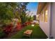 Spacious backyard featuring artificial grass, a cornhole set, and tropical landscaping for outdoor fun and relaxation at 1954 Goldenrod St, Sarasota, FL 34239
