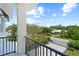 Enjoy the neighborhood view from this balcony overlooking lush landscaping and nearby homes at 1954 Goldenrod St, Sarasota, FL 34239