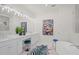 Spa-like bathroom with double vanity, colorful art, and a luxurious soaking tub at 1954 Goldenrod St, Sarasota, FL 34239