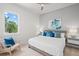 Calm bedroom features a large window, comfortable bed, and seating area with serene decor at 1954 Goldenrod St, Sarasota, FL 34239