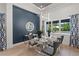 Elegant dining room with a modern chandelier, seating for six, and blue accent wall at 1954 Goldenrod St, Sarasota, FL 34239