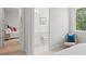 Hallway view showing bedroom and ensuite bathroom, complemented by natural light at 1954 Goldenrod St, Sarasota, FL 34239