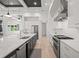 A modern kitchen with a center island, stainless steel appliances, and white countertops and cabinets at 1954 Goldenrod St, Sarasota, FL 34239