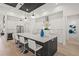 Bright, modern kitchen featuring a large center island with white countertops and stainless steel appliances at 1954 Goldenrod St, Sarasota, FL 34239