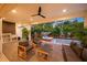 Covered outdoor space with lounge area and built-in kitchen next to the pool at 1954 Goldenrod St, Sarasota, FL 34239